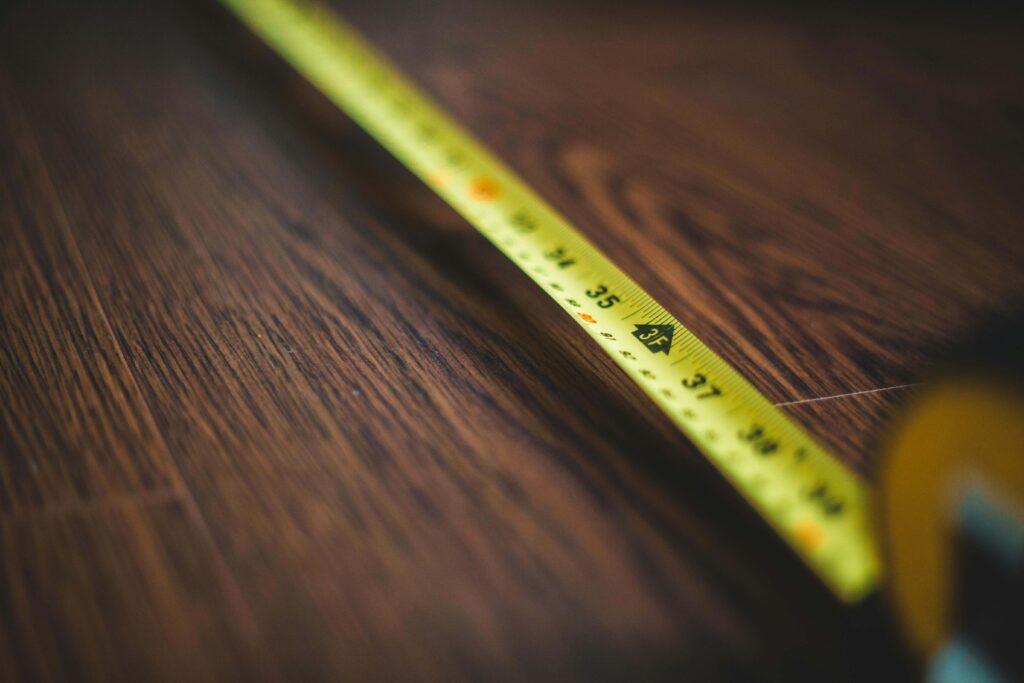 Measuring tape being used to measure furniture
